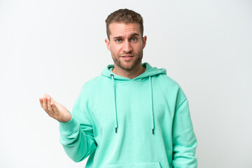 Fototapeta premium Young handsome caucasian man isolated on white background making doubts gesture