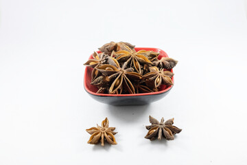 Pile of organic fresh whole star anise in a bowl isolated on white background. close up.top view.