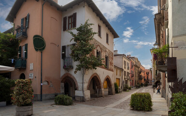 Fototapeta na wymiar Cuneo, Piedmont, Italy - October 14, 2022: Contrada Mondovì, ancient street in the historic center with medieval and nineteenth-century buildings at sunset