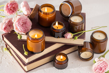 A set of different aroma candles in brown glass jars. Scented handmade candle. Soy candles are...