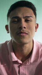 Obraz premium One serious hispanic latin man portrait face closeup looking at camera in vertical video