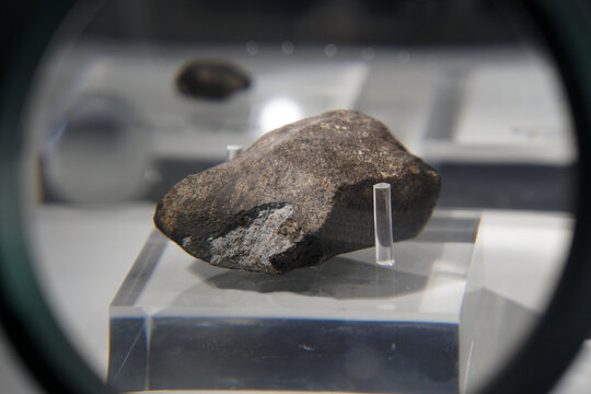 A sample piece of Chiang Khan chondrites meteorite stone. view through a magnifying glass.