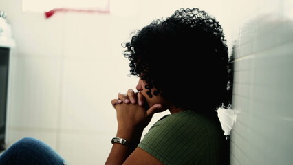 Faithful hispanic young woman praying to God during difficult times. South American Brazilian...