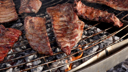 Meat on barbecue, Grilled pork ribs on bbq grill with hot charcoal and flames of fire