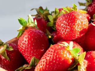 Fresh, red and delicious strawberries on a light background