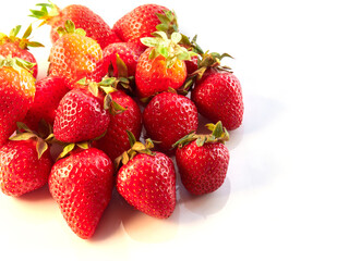 Fresh, red and delicious strawberries on a light background