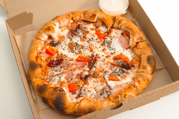 Small pizza in an open box, food delivery