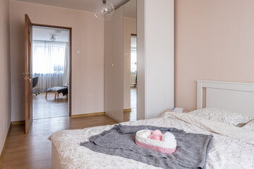 Fototapeta na wymiar beautiful bright bedroom Scandinavian interior, double bed, handmade basket on the blanket