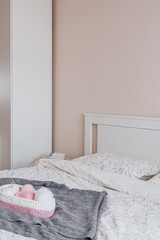 beautiful bright bedroom Scandinavian interior, double bed, handmade basket on the blanket
