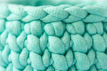 close-up of a beautiful cozy crochet basket, pattern for crocheting, a nice hobby in the winter evenings. Sustainable, organic lifestyle advertising.
