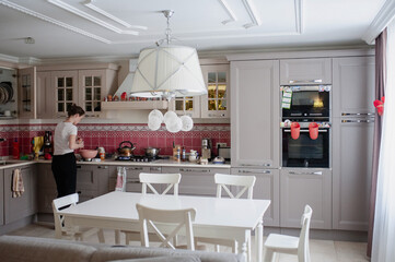 Woman cleaning in a beautiful bright kitchen