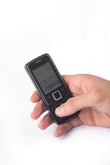 hand holding a vintage mobile phone isolated on white background