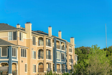 Austin, Texas- Apartment building near Lake Austin with blue and beige exterior