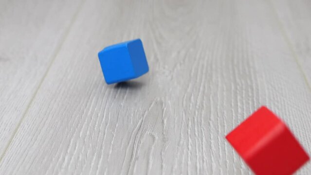 Children's play wooden toy blocks fall to the floor. Slow motion.