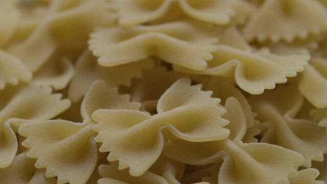 raw pasta in the form of bows rotate in a circle