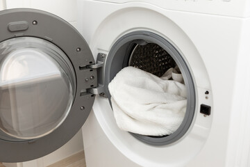 Modern washing machine with clean or dirty clothes in the middle