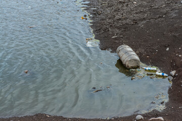 pollution of nature, plastic and rubber in water. environmental disaster