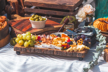 Sunny event at beach salon with cheese board and italian food on table with pasta