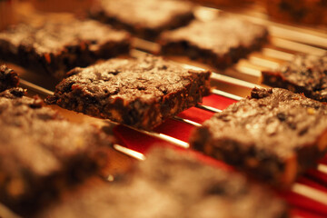 Close-up of freshly baked chocolate brownie on baking rack