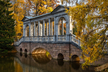 Marble bridge in the autumn park in the city of Pushkin near St. Petersburg