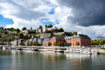 The waterfront of Namur on the river Meuse, sight from a bridge - obrazy, fototapety, plakaty