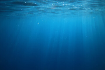 ocean underwater rays of light background, under blue water sunlight