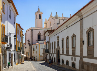 Fototapeta na wymiar Portugal, August 2022: Traditional street with typical white buildings in Évora, Algarve, Portugal
