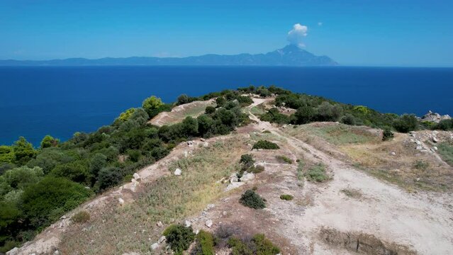 Aerial view of Halkidiki peninsula in Greece. Drone shot of Atos mountain with clear blue water on a sunny day