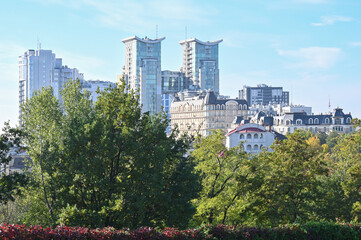 View of modern skyscrapers from the botanical garden in the city of Kyiv 
