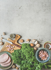 Kale cooking background with fresh kale leaves, smoked pork meat and mushrooms , top view, frame