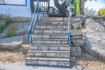 Staircase with concrete blocks steps and blue metal handrails to at Lake Austin- Austin, TX