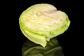 Fototapeta premium One half head of fresh cabbage, macro, isolated on black background.