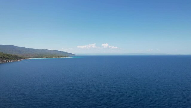 Aerial view of Halkidiki peninsula in Greece. Drone shot of Atos mountain with clear blue water on a sunny day