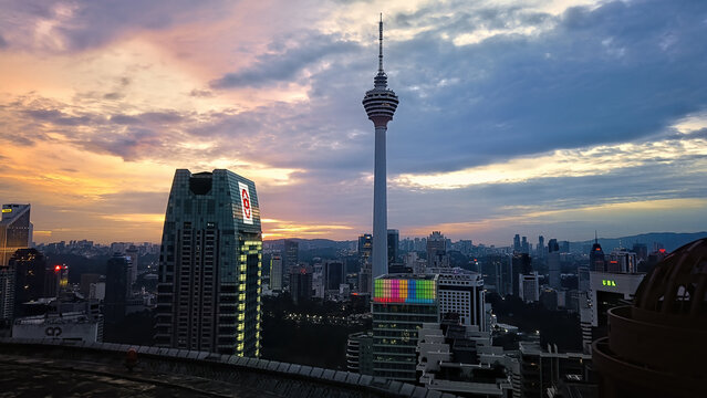 KL Tower, can be seen against the backdrop of a sunset.