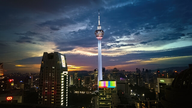 KL Tower, can be seen against the backdrop of a sunset.