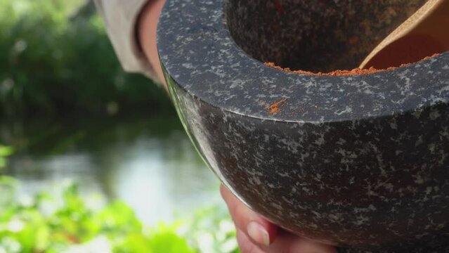 Spoon pours out ground pepper