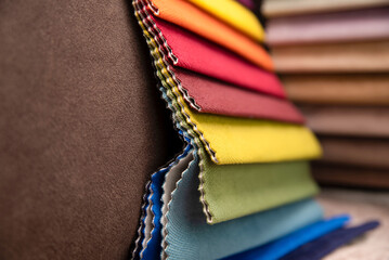 A close-up of a fabric catalog in a furniture store. Choosing fabric for upholstered furniture or...