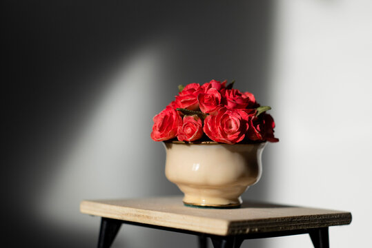 Lonely Vase Of Red Flowers On A Table