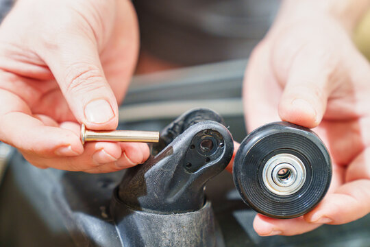 replacing the old erased wheel on the suitcase with a new one. the concept of reasonable consumption and repair of old things. repairman's job.