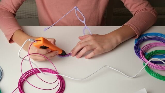 Teen Girl Using 3d Pen. Printing with Colored Plastic Wire Filament. Child making a Christmas Three, drawing with 3D pen. Artwork, Robotics. STEAM, STEM education. Modern Technologies. Study at home.