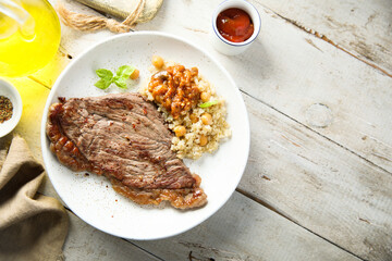Beef steak with chickpea and vegetable sauce
