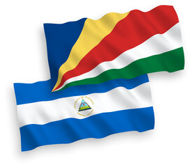 Fototapeta premium Flags of Nicaragua and Seychelles on a white background