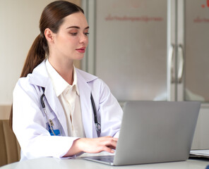 Female doctor meeting with medical teamwork woman using laptop computer in hospital. Beautiful professional healthcare expertise talking, explaining discussion with teamwork in medical clinic.