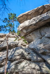 Autumn landscape with trees and rocks on top of a mountain against the sky