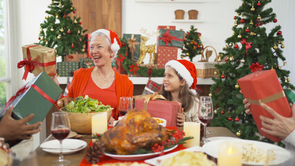 A group of multi ethnic. Portrait of Caucasian and African American black family, woman have a celebration dinner in party on Merry Christmas Eve Xmas on holiday at home.People lifestyle. thanksgiving