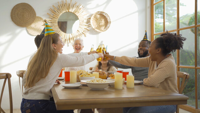 A Group Of Multi Ethnic. Portrait Of Caucasian And African American Black Family, Woman Have A Celebration Dinner In Party On Holiday At Home.People Lifestyle. Reunion.