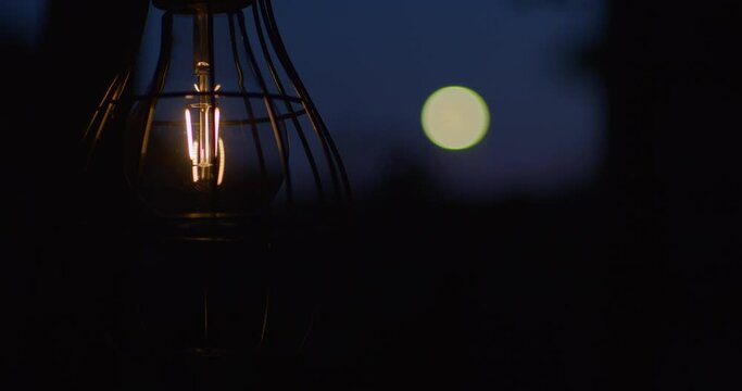 Solar bulb light and the moon in the background in the evening time | 4k  clean 12-bit, source footage: bmd raw original file