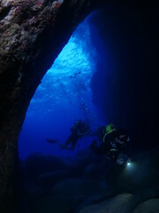 Fototapeta na wymiar caves underwater cave dive blue background scuba divers to explore