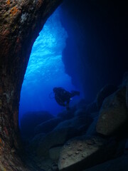 Fototapeta na wymiar caves underwater cave dive blue background scuba divers to explore
