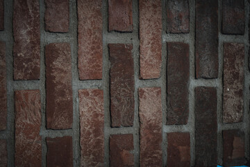 Close-up of red wall background. Premium colorful abstract background with dynamic shadow on background, consisting of red bricks and stones, gradient color, artistic texture, epic background